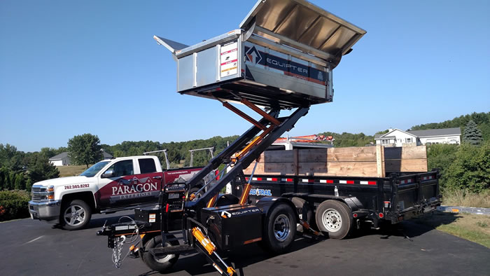 A Paragon Exteriors truck and equipment at a job site. 