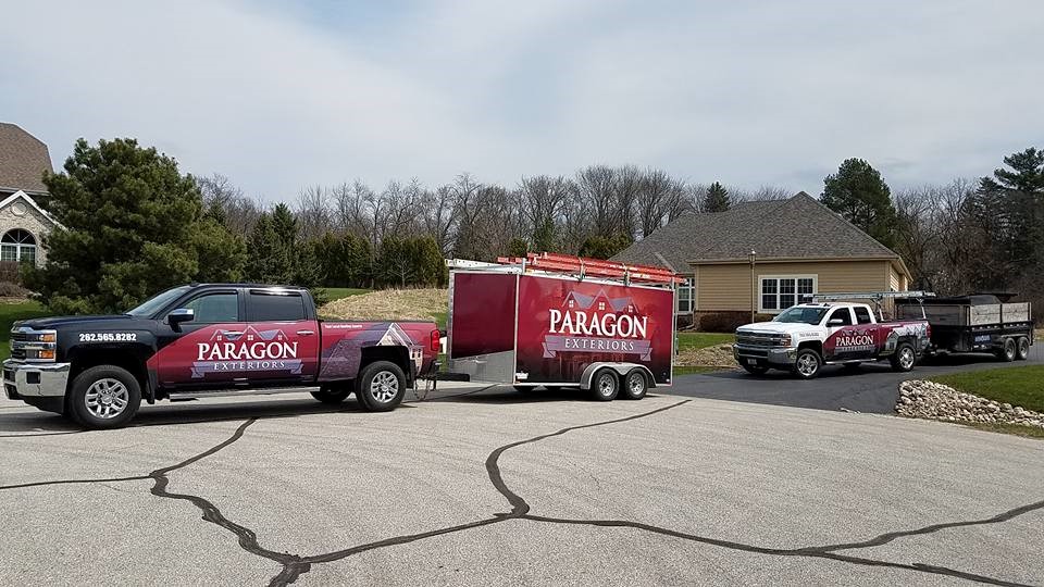 Paragon Exteriors LLC Trucks and Trailers On Hartland Wisconsin Job site.